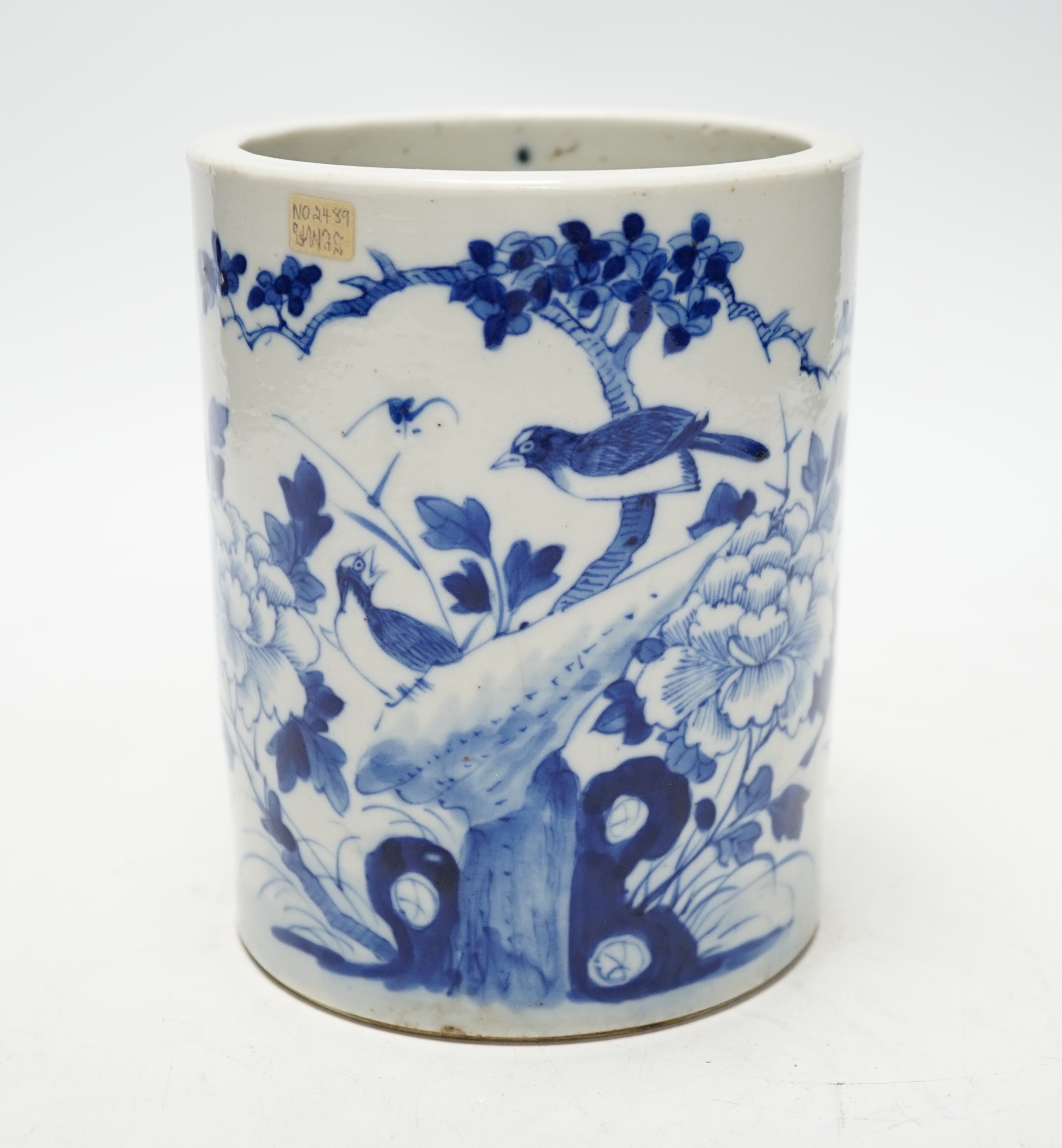 A 19th century Chinese cylindrical blue and white brushpot, later drilled holes, 15cm